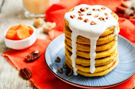 Carrot pancakes with sweet Greek yogurt sauce and pecan sprinkling. - Greek Yogurt Pancakes