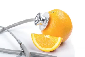 Orange with stethoscope on white background, Vitamin C deficiency Symptoms